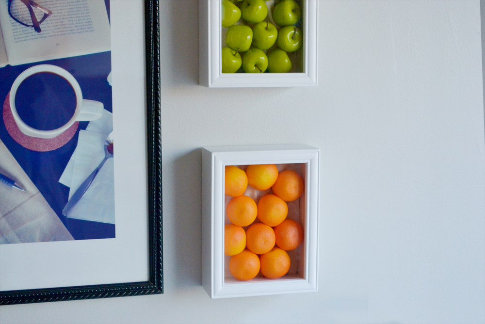 Fake fruits framed on wall