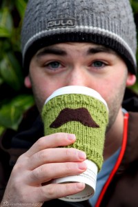 Knitted mustache coffee sleeve