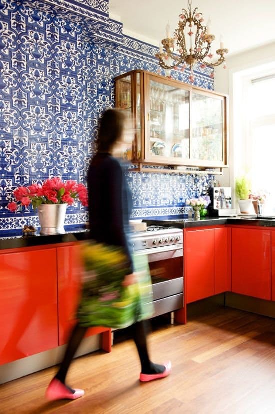 Blue patterned walls red kitchen