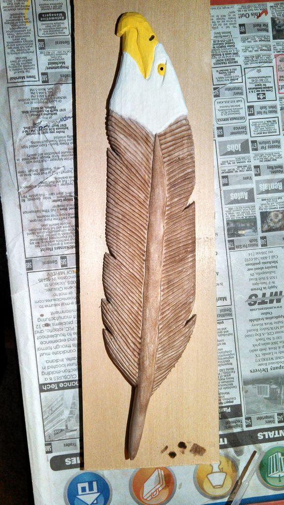 Carved and painted eagle feather