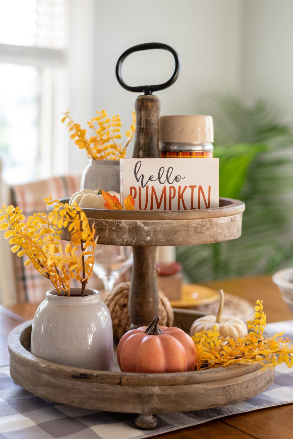 Tiered tray decorated for fall with mini pumpkins