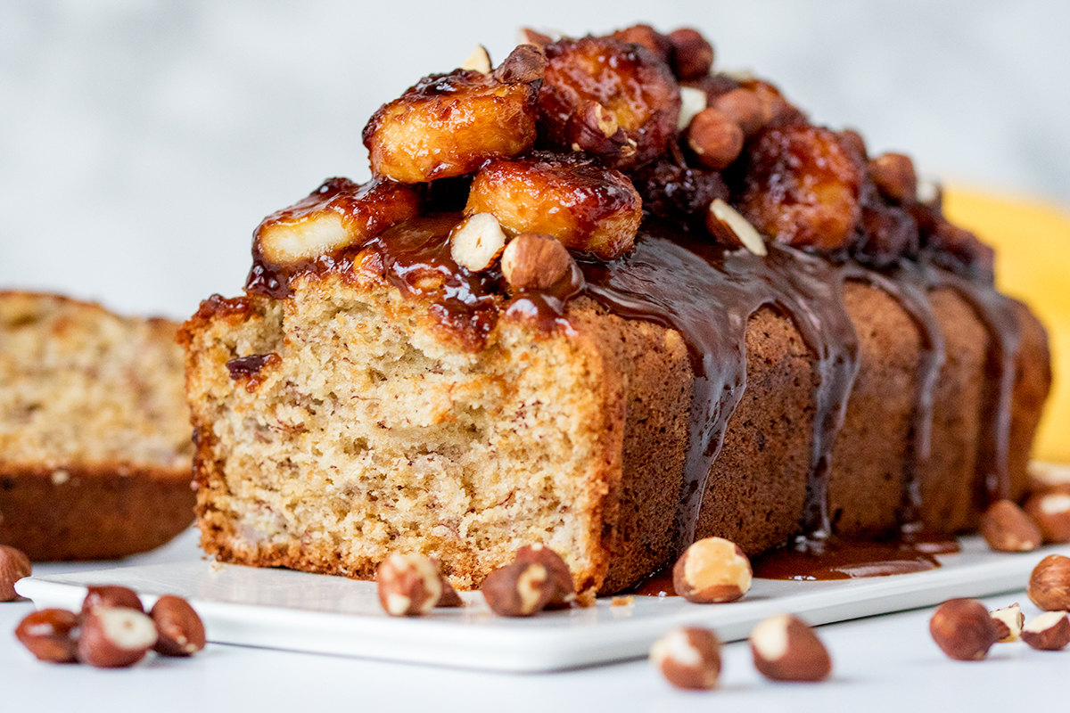 A beautifully moist banana bread topped with sticky-sweet bananas and crunchy hazelnuts.
