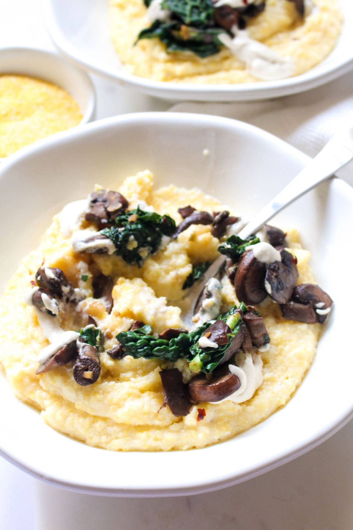 Serve polenta with mushroom ragout and dairy free cream sauce