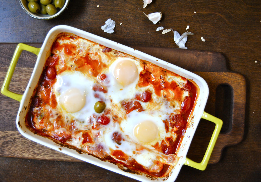 Baked feta with olive, tomatoes, and eggs