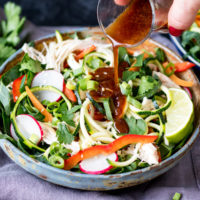 Thai chicken zoodle bowl with a delicious nutty dressing.
