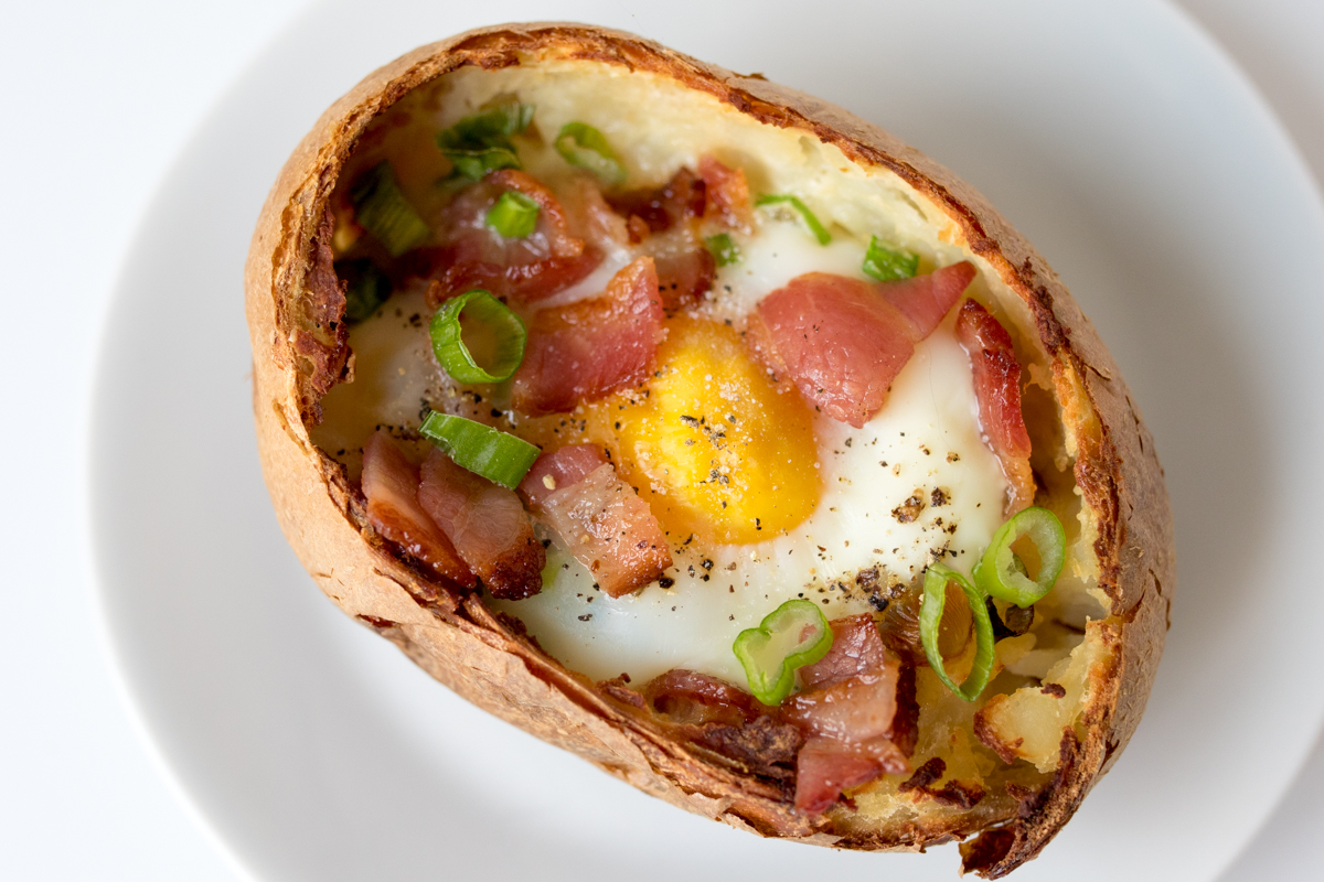 Baked egg breakfast boats with bacon and scallions finished