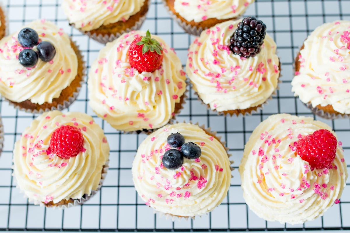 Gluten Free Berry Cream Cupcakes - Light and fluffy cupcakes, packed with fresh berries and topped with cheesecake cream!