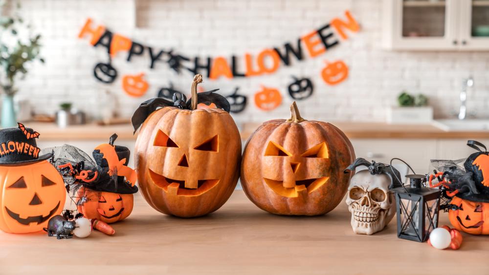 Carved Pumpkins, Smiling, on a Table Out of Doors Facing and Side