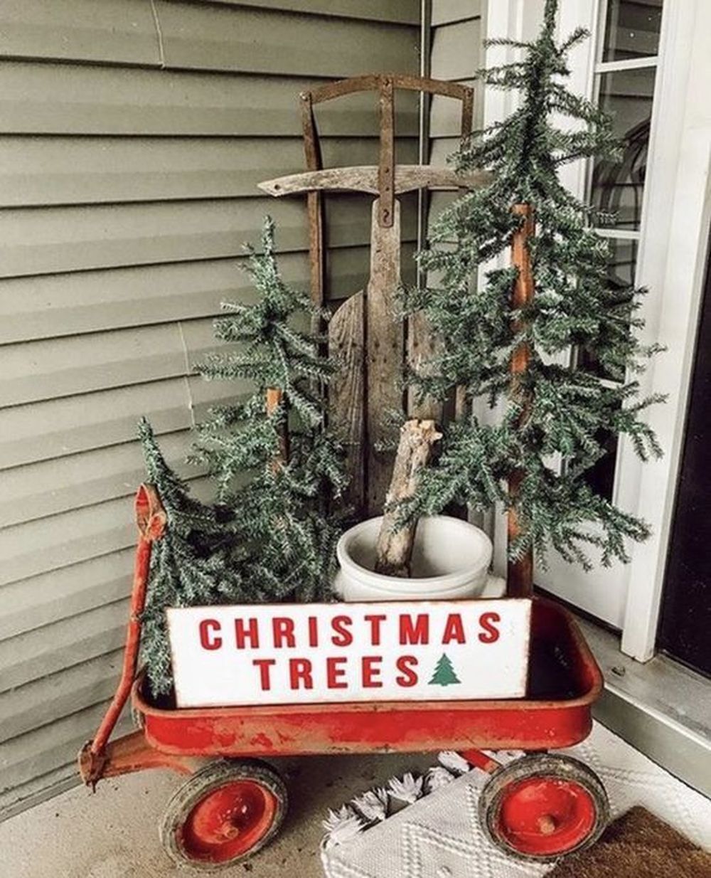 Cart filled front porch christmas trees