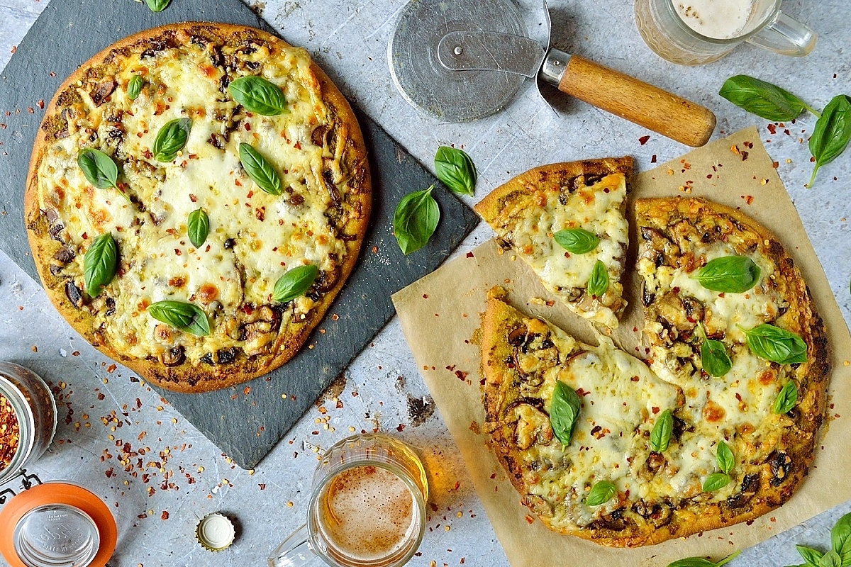 Mushroom and basil pesto pizza - crisp, chewy homemade pizza dough topped with basil pesto, garlic mushrooms and plenty of mozzarella and cheddar cheese!