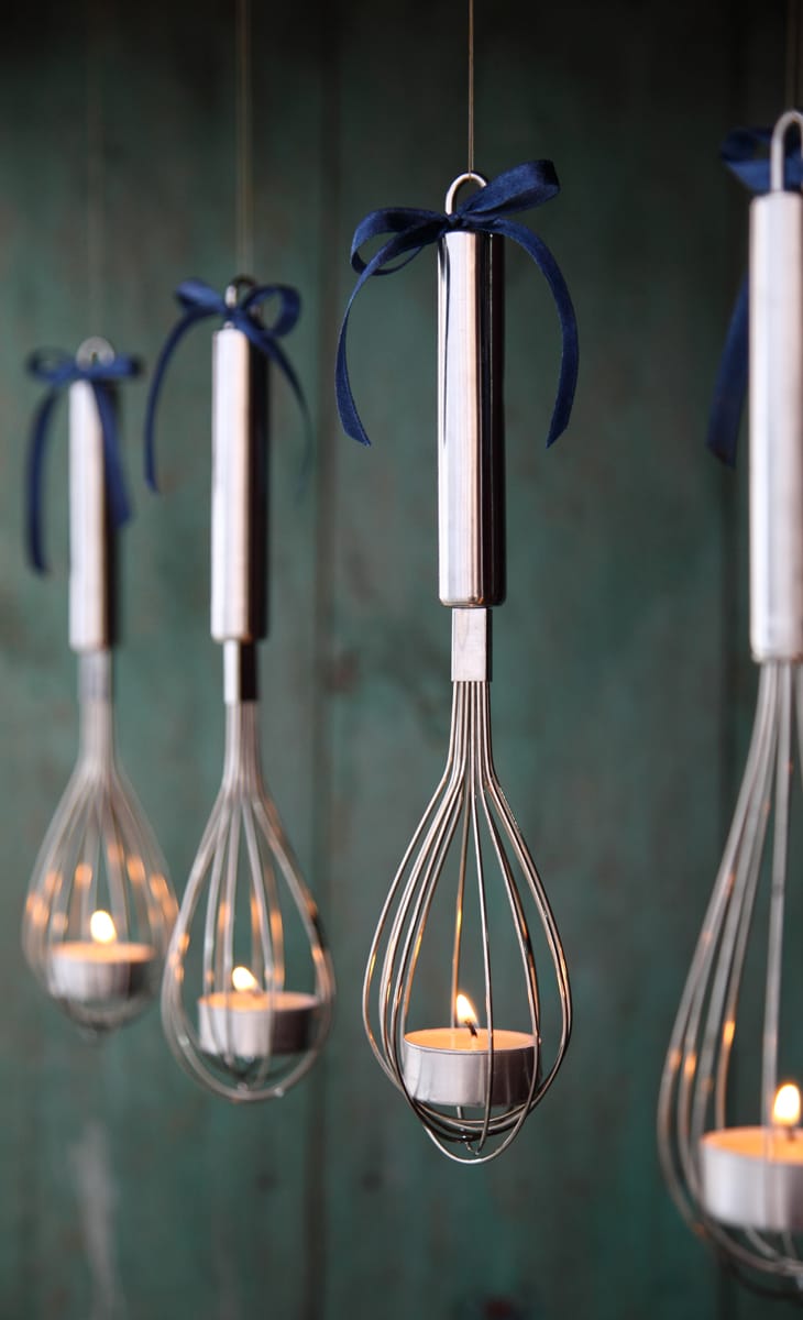 Hanging whisk candle holding