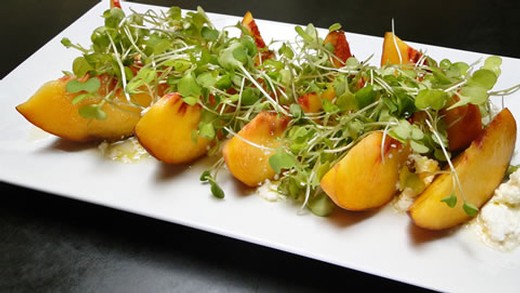 Peach and goat cheese salad with kale microgreens