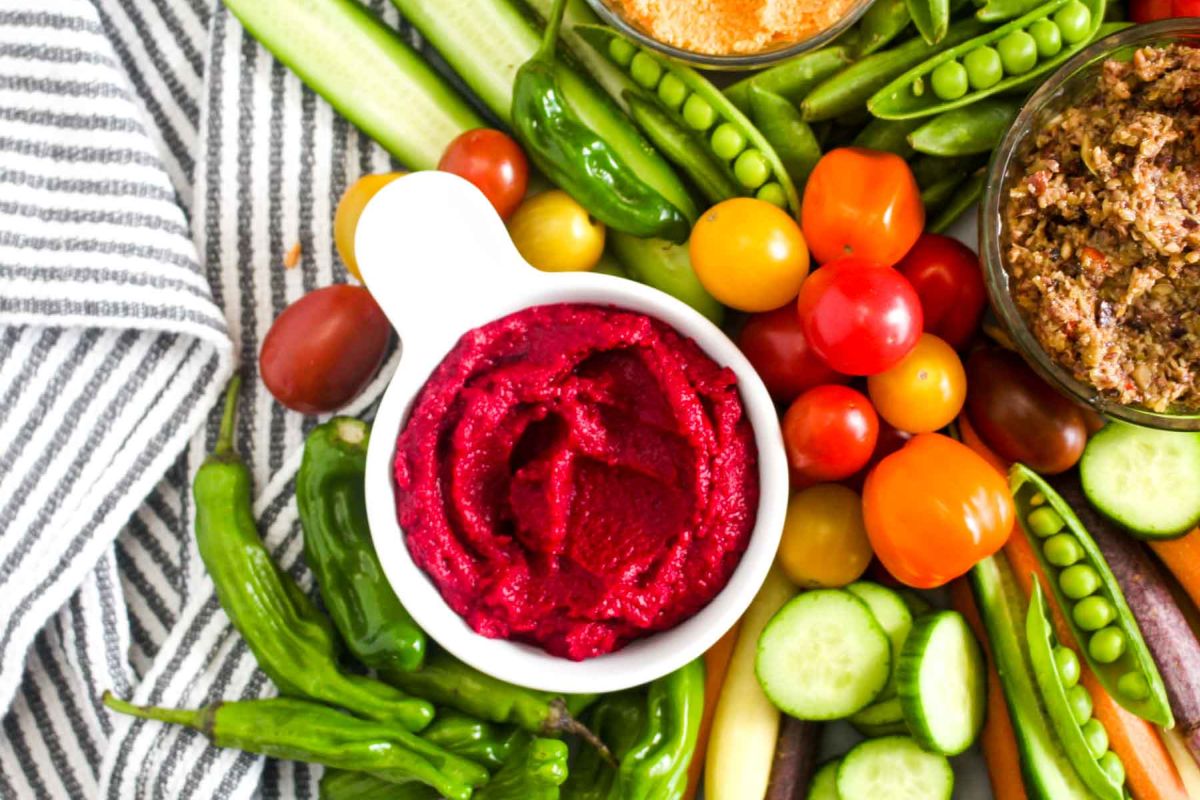 Eat colorful homemade crudités platter with three dips