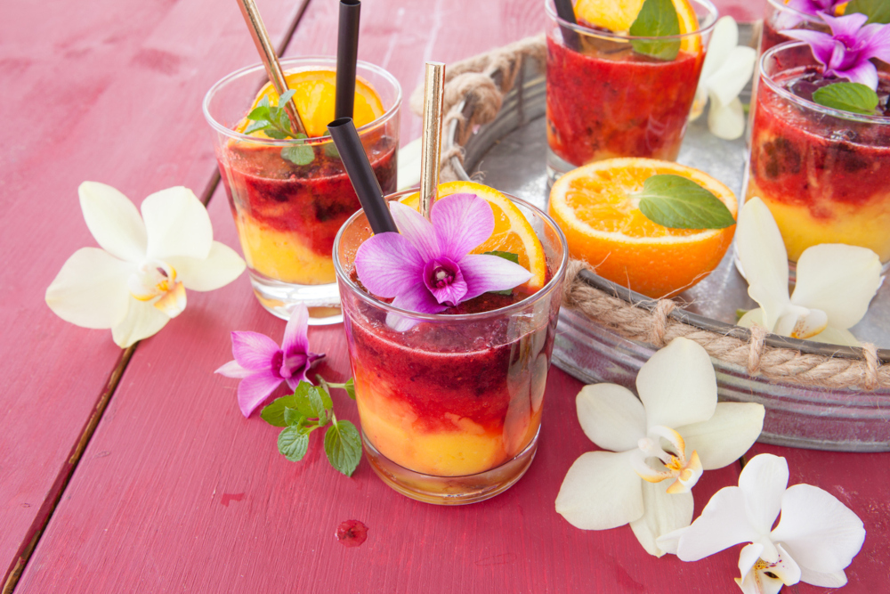 Grenadine and orange cocktail with orchids