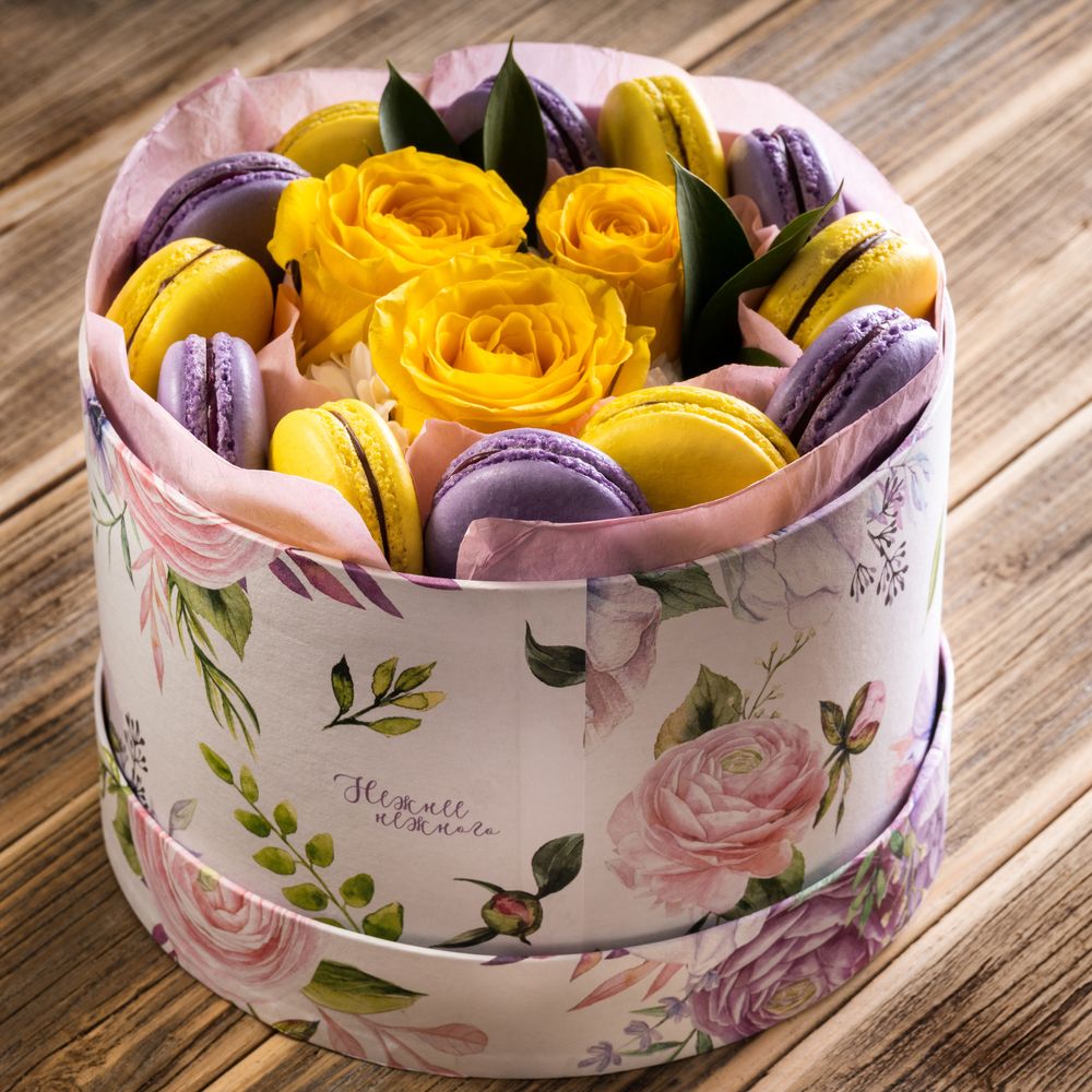 A box of purple and yellow macaroons candy bouquet 