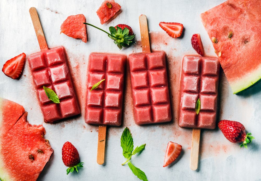Strawberry and watermelon ice cream popsicles with mint candy arrangements 