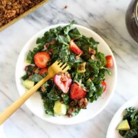 Strawberry avocado kale salad with savory granola top