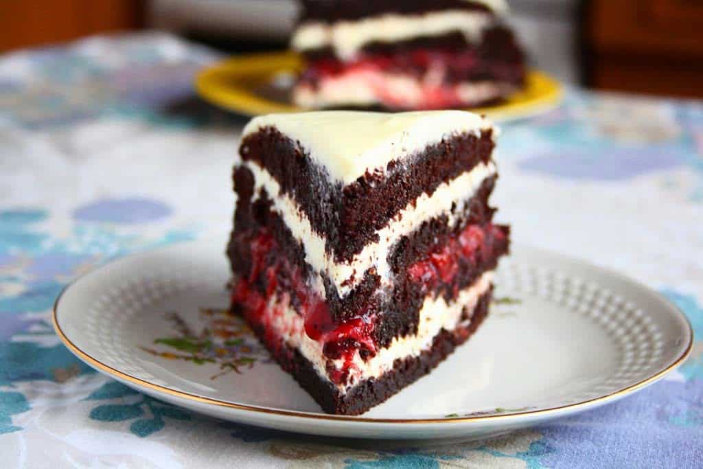 Chocolate layer cake with white chocolate cream cheese icing and strawberry jam