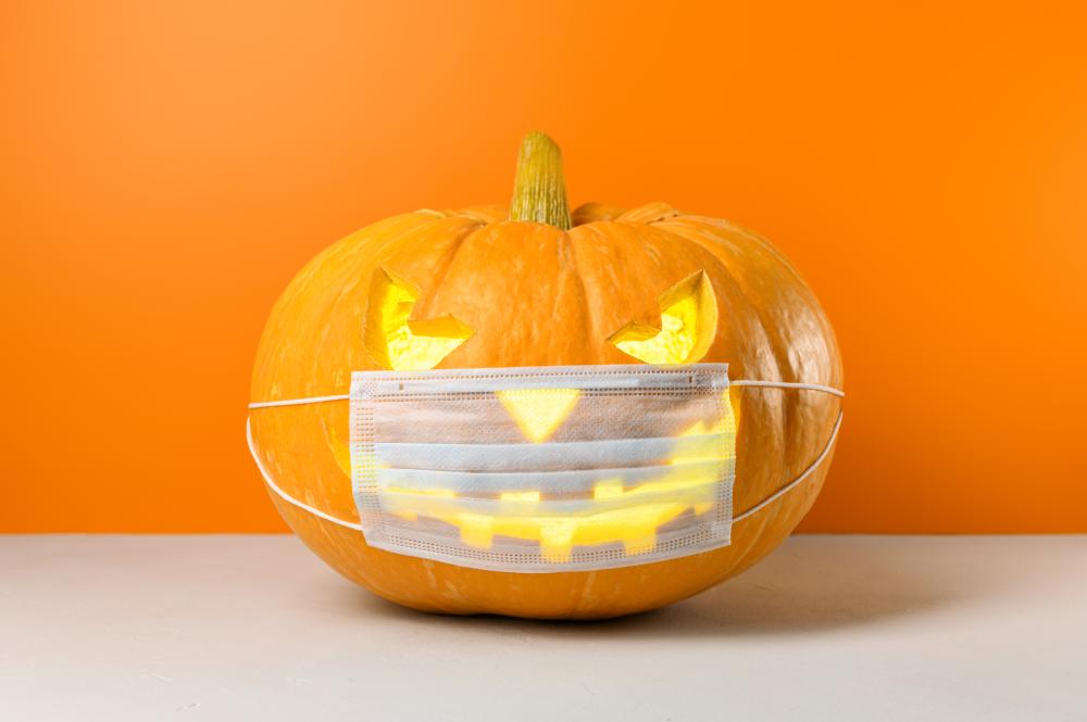 Halloween pumpkin carving with medical mask