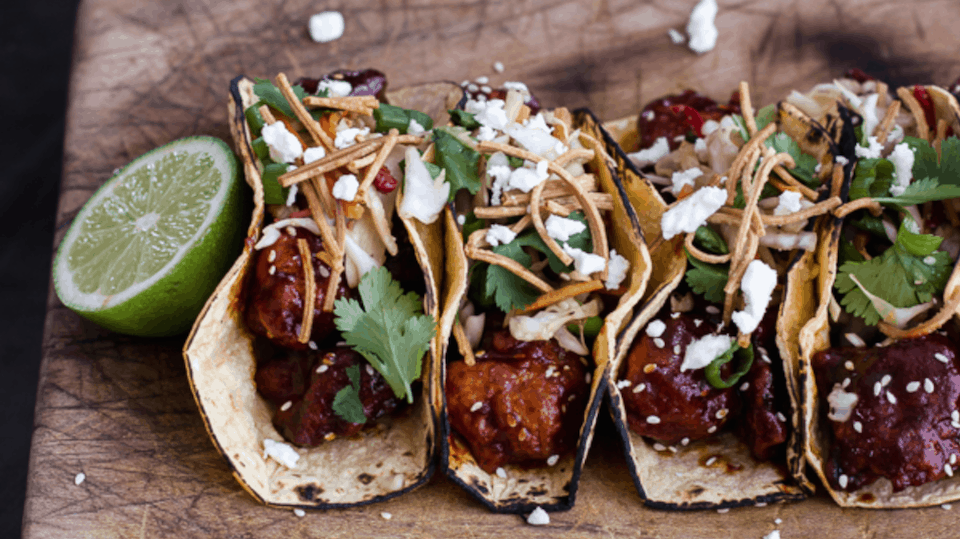 Korean fried chicken tacos with sweet slaw, crunchy noodles, and queso fresco