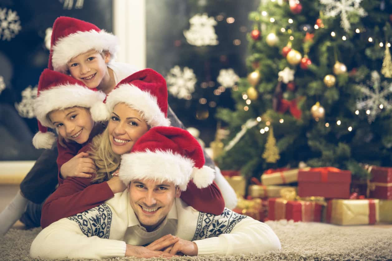 Family Pile with Santa Hats Christmas Photo