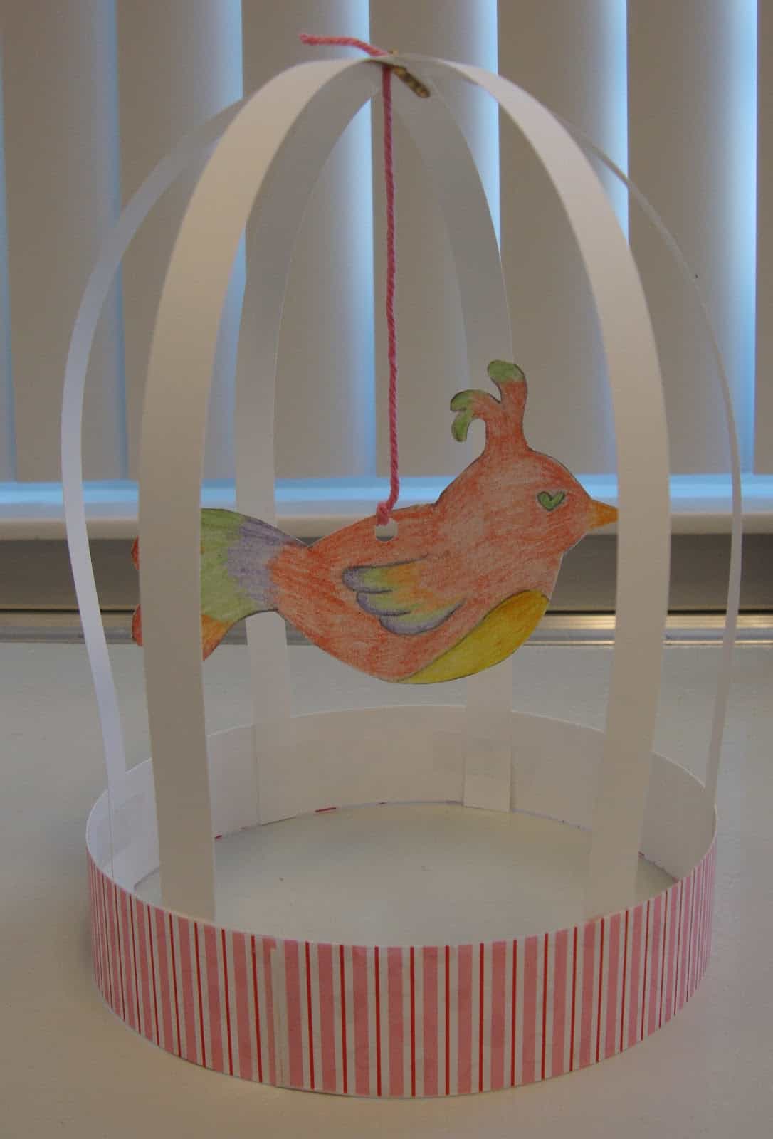 Pretty parrot and paper birdcage