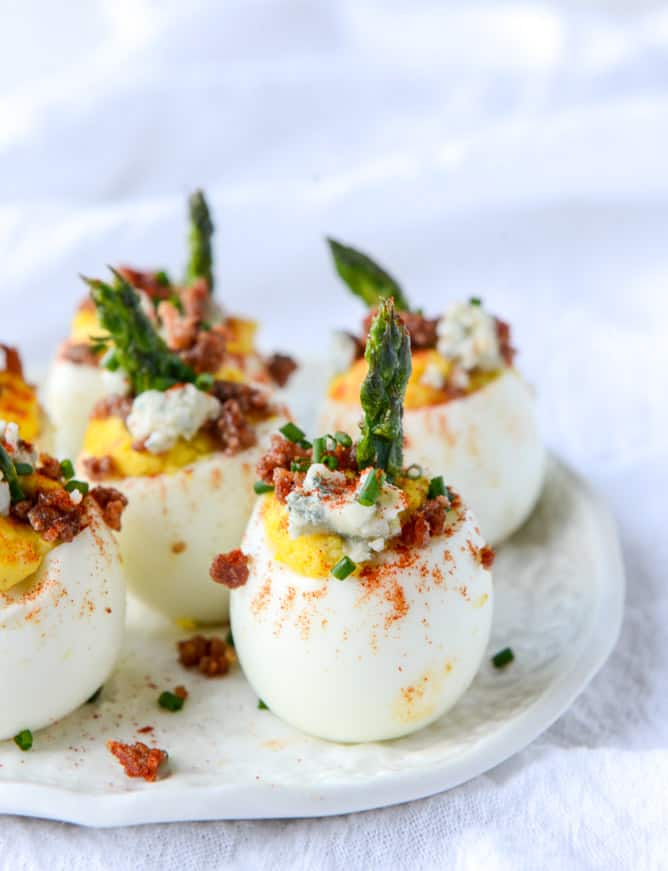 Bacon blue deviled eggs with roasted garlic and asparagus
