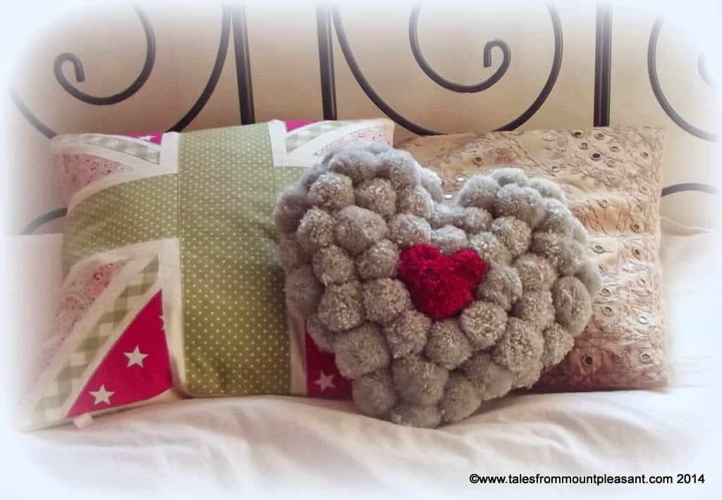 Colourful pom pom heart pillow