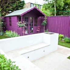 Brightly coloured fence and matching shed