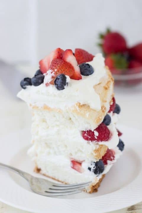 Angel food cake with coconut whipped cream and berries