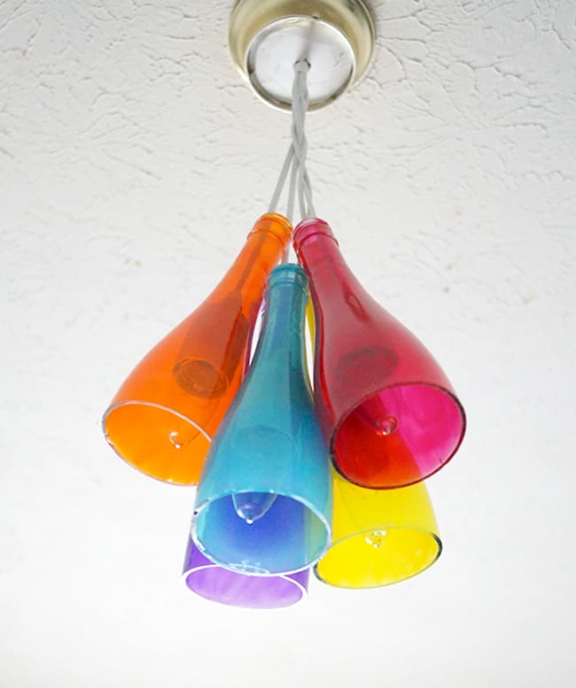 Colourful wine bottle chandelier