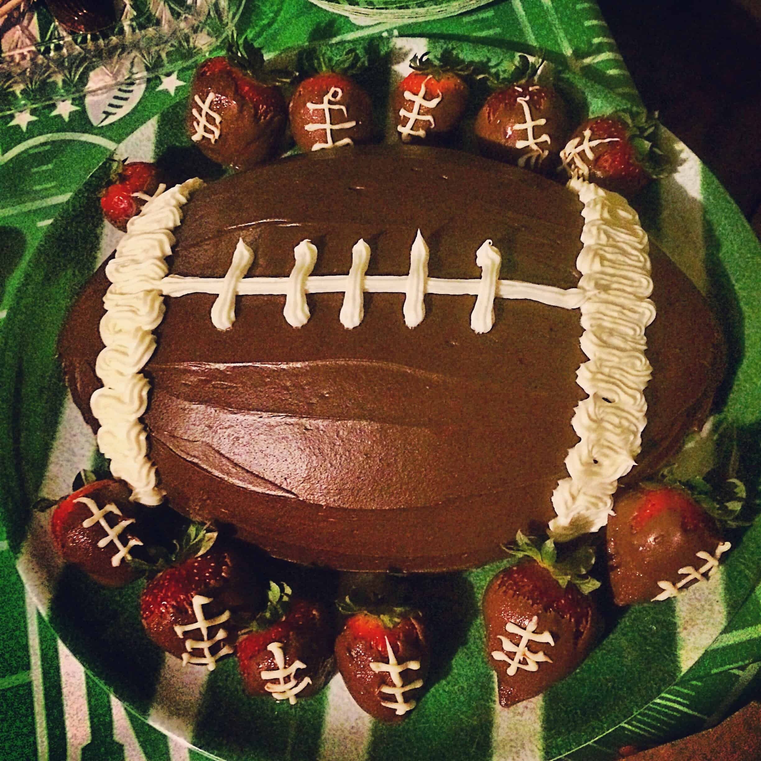 Football cake with chocolate covered foorball strawberries