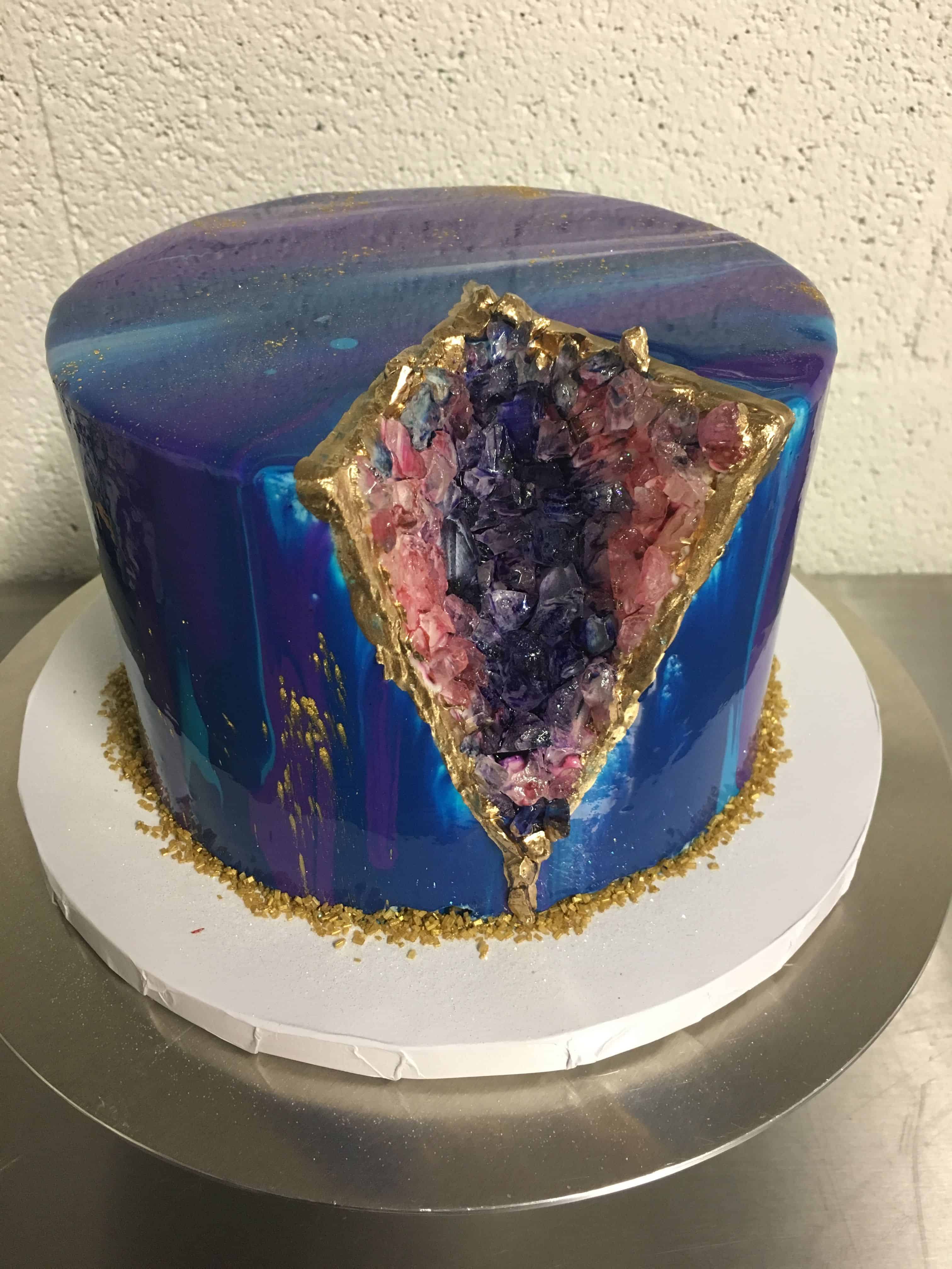 Mirror glaze cake with gold, pink, and blue geode