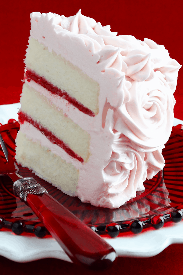 Pink champagne velvet layer cake with strawberry raspberry filling