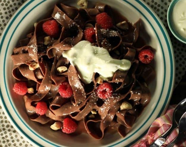 Chocoate pasta with chocolate hazelnut cream sauce, white chocolate shavings, and fresh berries