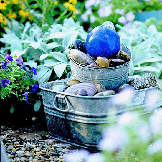 Stacked pale, rock, and glass orb fountain