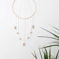 Modern metallic, wood, and white dreamcatcher inspired wall hanging