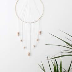 Modern metallic, wood, and white dreamcatcher inspired wall hanging