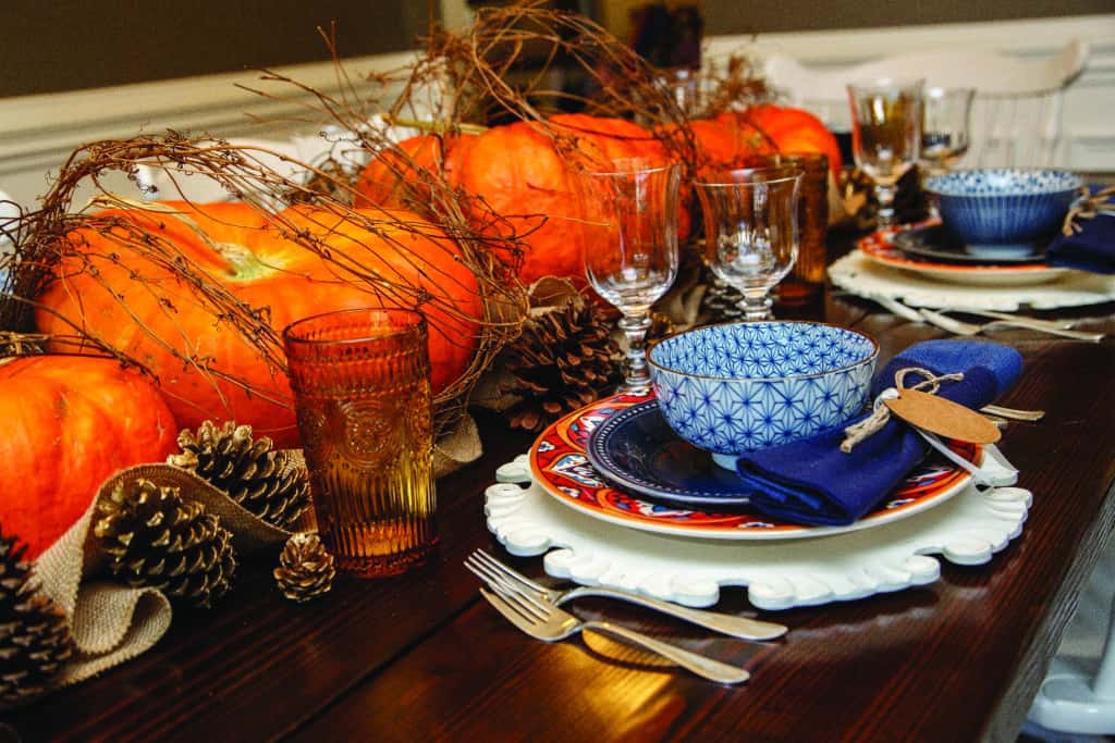 Branch wrapped pumpkins and pinecones thanksgiving table