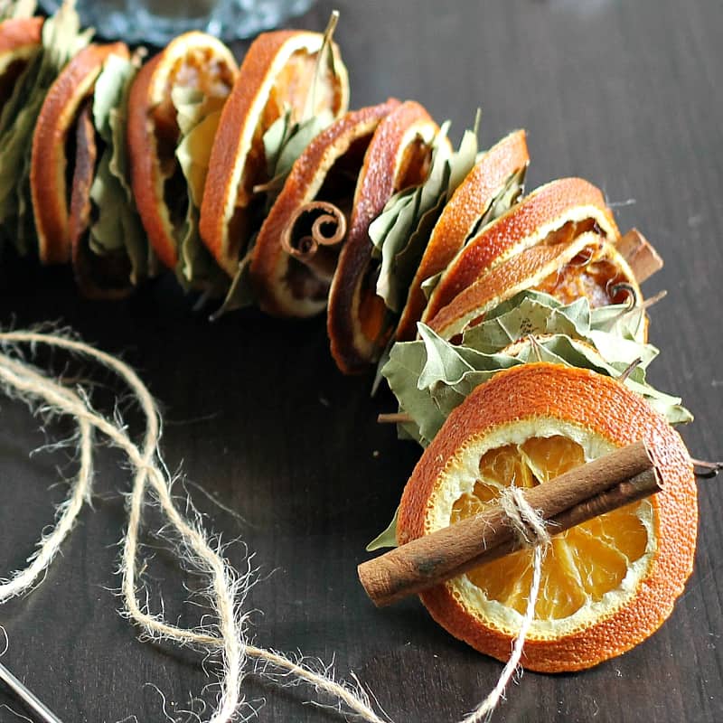 Old fashioned dried orange garland with bay leaves and cinnamon sticks