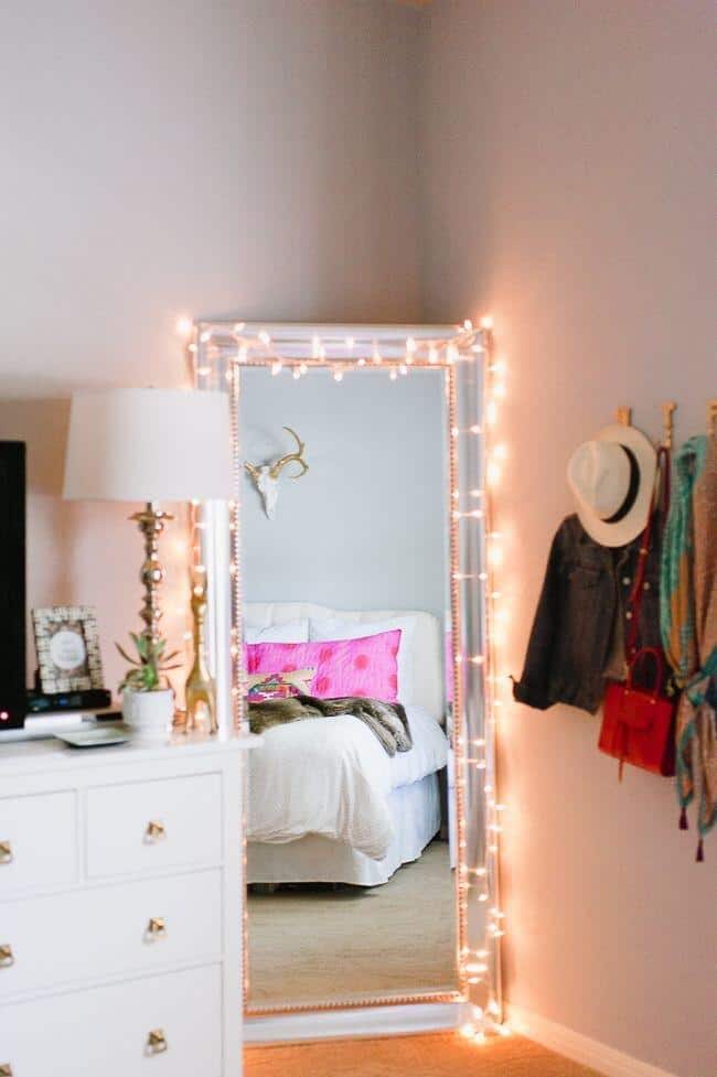 String lights over standing mirrors