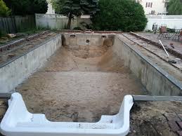 Full in ground pool with a hot tub at one end