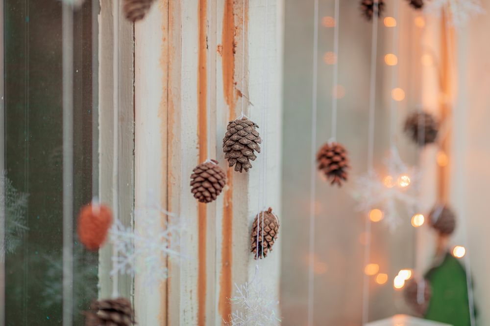Simply hanging pinecones christmas window display