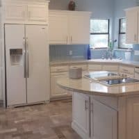 White painted cabinets using old fashioned white washing techniques