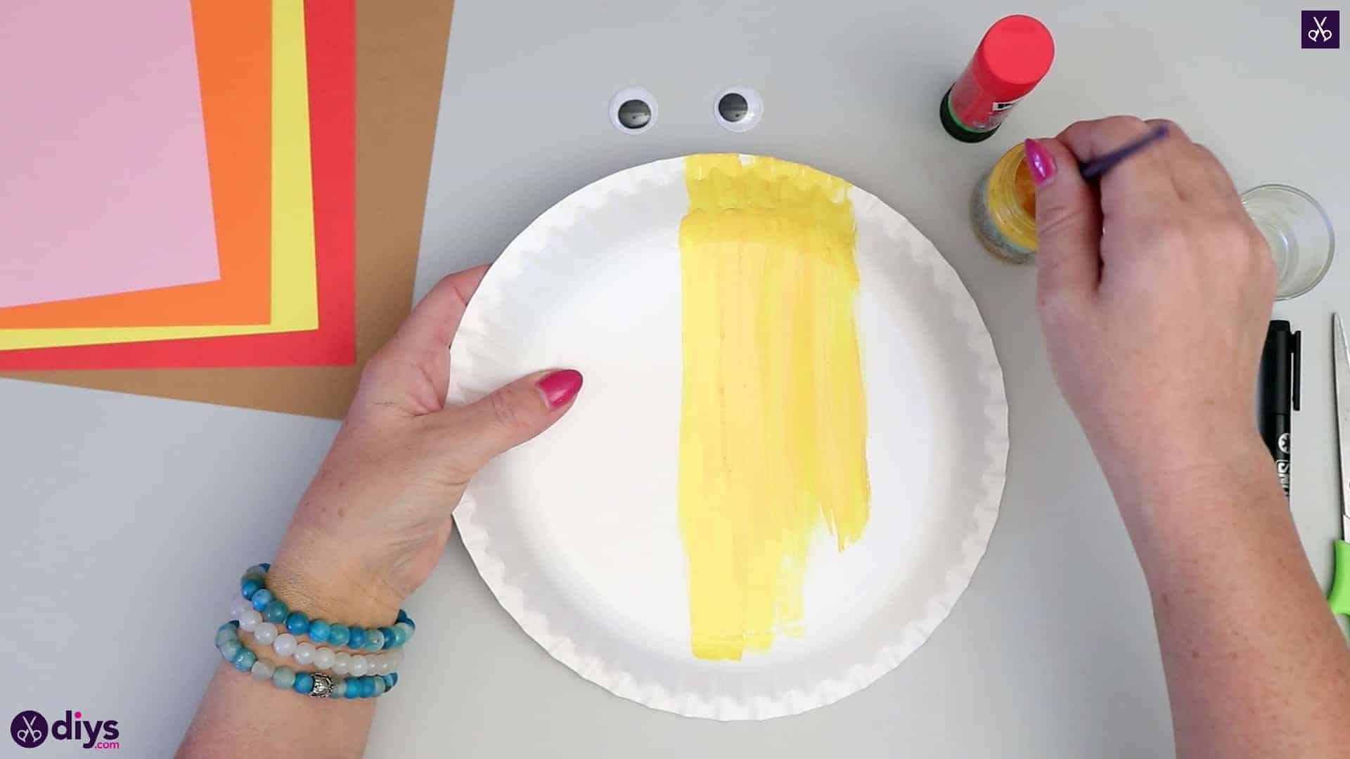 Paper plate scarecrow paint in yellow