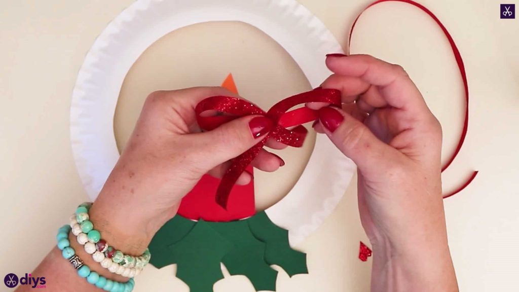 Paper plate wreath with a candle bow
