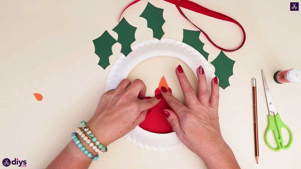 Paper plate wreath with a candle press