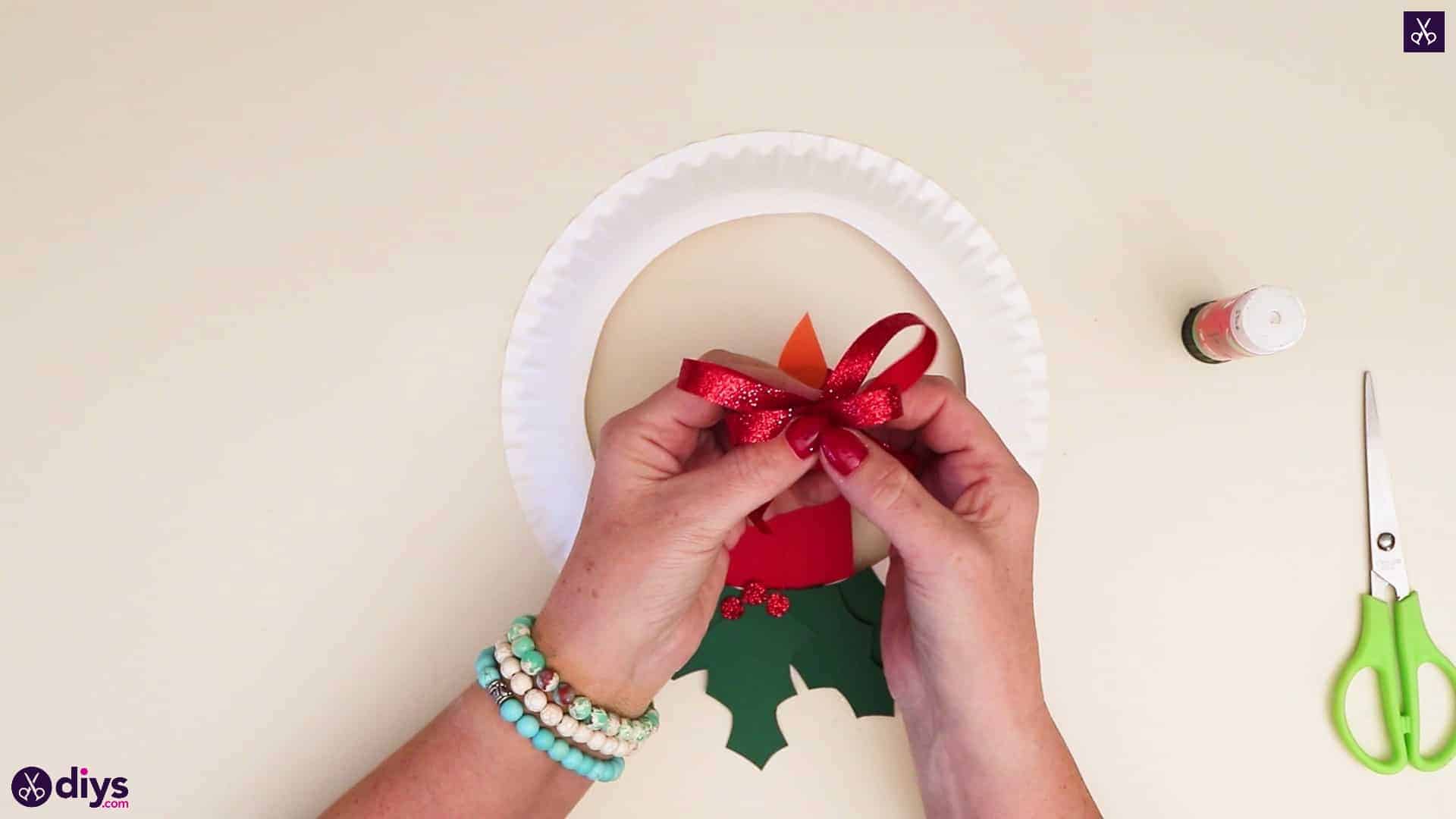 Paper plate wreath with a candle top bow