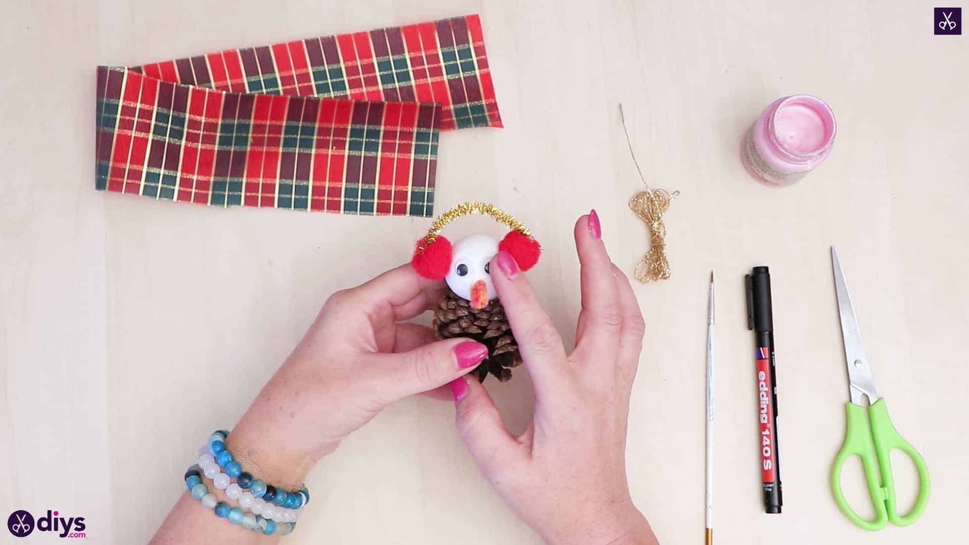 Pinecone snowman with headphones attach eye