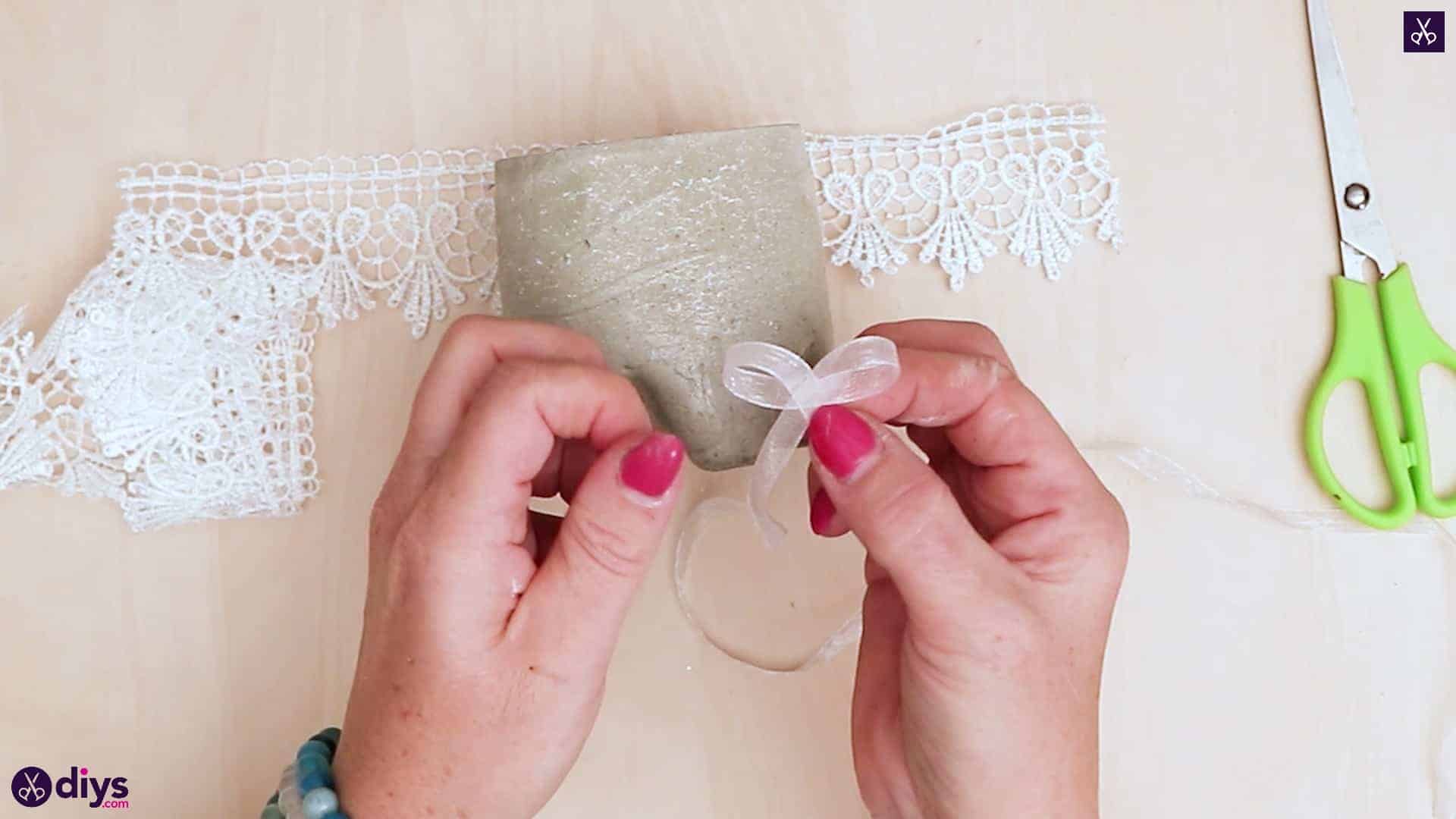 Concrete candle holder from a plastic bottle add lace on top